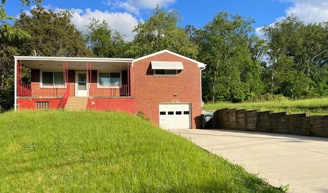 6729 Highland Ave, Union Twp Wsh, PA 15332 - view of front facade featuring an attached garage, driveway, brick siding, and a front lawn