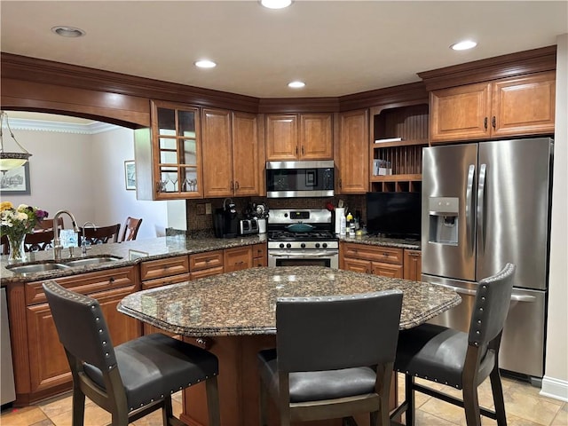 7039 Clubview Dr, South Fayette, PA 15017 - kitchen featuring appliances with stainless steel finishes, a sink, brown cabinets, a breakfast bar, and ornamental molding