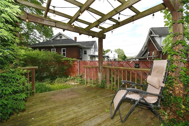 wooden terrace featuring a pergola and fence