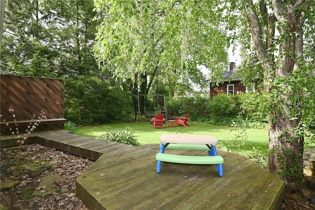 view of grassy yard with a deck