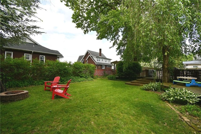 view of yard featuring a fire pit and a wooden deck