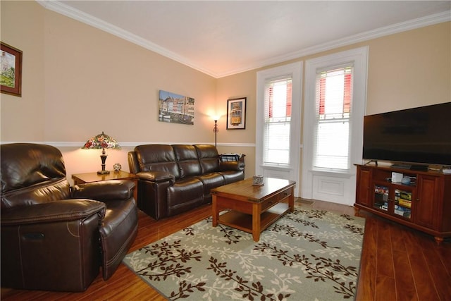 living area with ornamental molding and wood finished floors