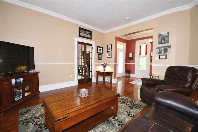 living area featuring wood finished floors, ornamental molding, french doors, and baseboards