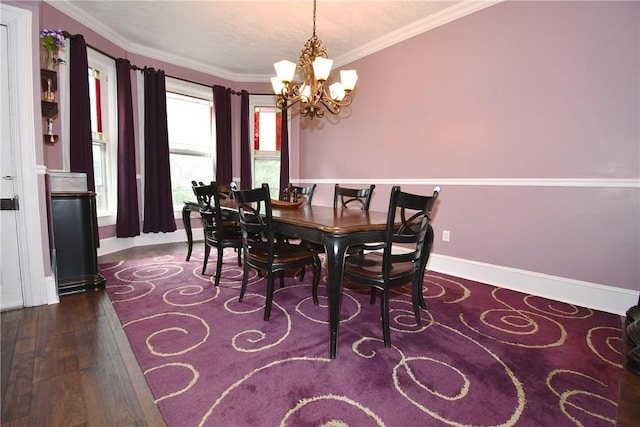 dining room with a chandelier, wood finished floors, crown molding, and baseboards