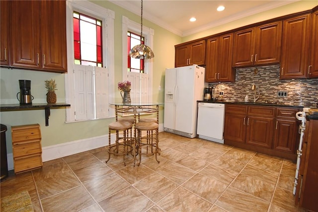 kitchen with white appliances, a sink, ornamental molding, dark countertops, and backsplash