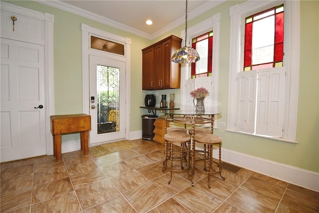 dining area with crown molding, baseboards, and recessed lighting