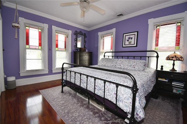 bedroom featuring baseboards, wood finished floors, ornamental molding, and ceiling fan