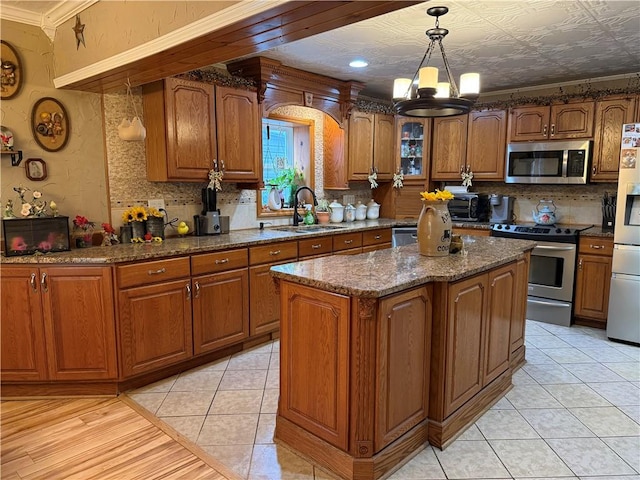 2650 Georgeville Rd, S Mahoning/Plumville, PA 15759 - kitchen featuring stainless steel appliances, a sink, brown cabinets, a chandelier, and backsplash