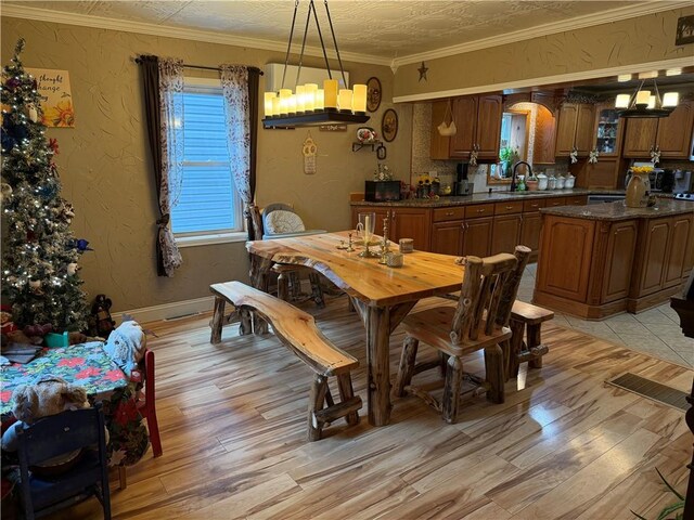 2650 Georgeville Rd, S Mahoning/Plumville, PA 15759 - dining area with light wood-style flooring, a chandelier, ornamental molding, and baseboards
