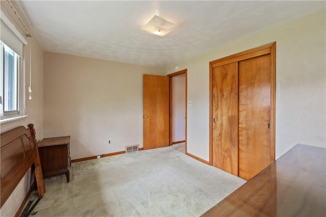 106 High St, Elizabeth Twp/Boro, PA 15037 - unfurnished bedroom featuring baseboards, light carpet, and a closet