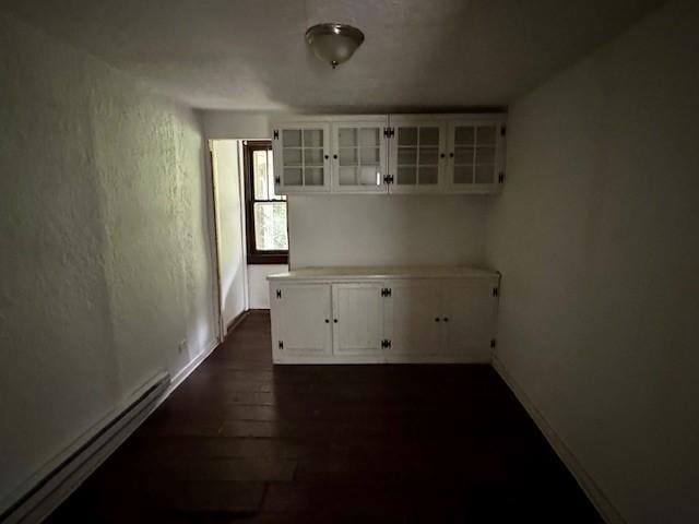 15 Allen Way, White Oak, PA 15131 - unfurnished dining area featuring baseboards, a baseboard radiator, and dark wood finished floors