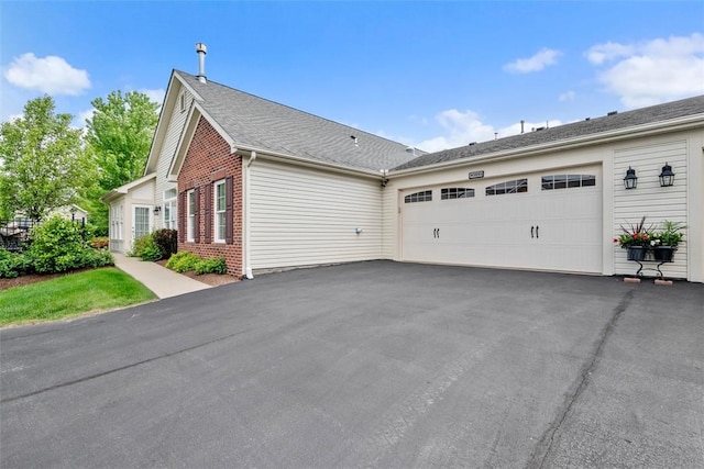 2053 Isleworth, Cranberry Twp, PA 16066 - view of side of property with brick siding, an attached garage, and asphalt driveway