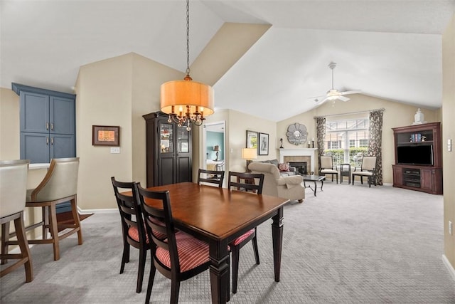 2053 Isleworth, Cranberry Twp, PA 16066 - carpeted dining space with lofted ceiling, a glass covered fireplace, ceiling fan, a chandelier, and baseboards