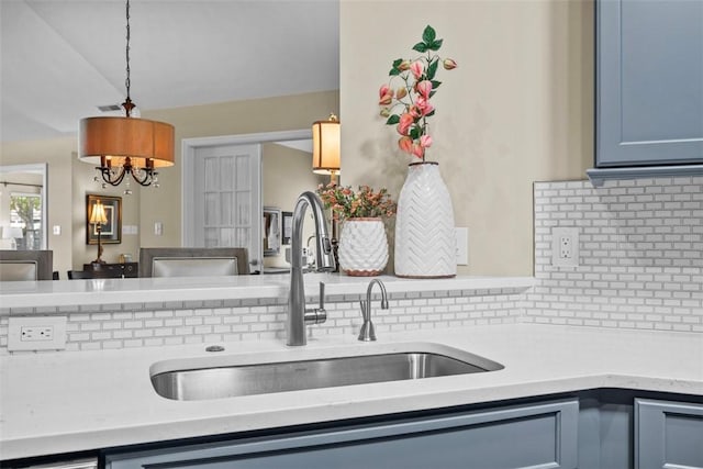 2053 Isleworth, Cranberry Twp, PA 16066 - kitchen with a sink, light countertops, tasteful backsplash, and decorative light fixtures