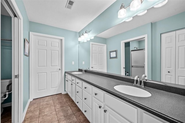 2053 Isleworth, Cranberry Twp, PA 16066 - full bath with double vanity, a closet, tile patterned floors, baseboards, and toilet