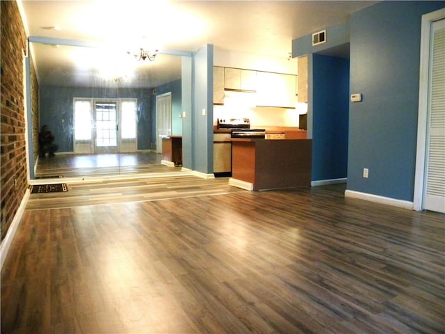 1080 Chatham Park Dr Unit F, Scott Twp Sal, PA 15216 - unfurnished living room with a chandelier, dark wood-style flooring, brick wall, and baseboards