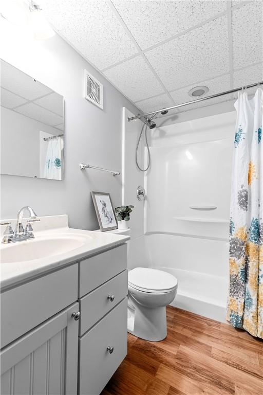 611 Calais Dr Unit 4108, Mccandless, PA 15237 - bathroom with a paneled ceiling, wood finished floors, a shower with shower curtain, vanity, and toilet
