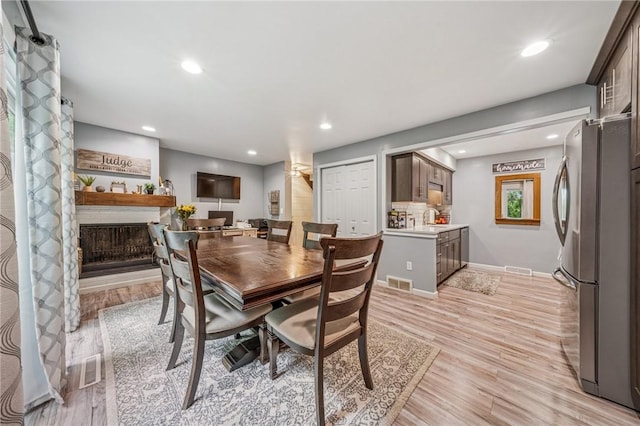 436 Allenberry Dr, Ross Twp, PA 15237 - dining area featuring light wood-type flooring, recessed lighting, a fireplace, and baseboards