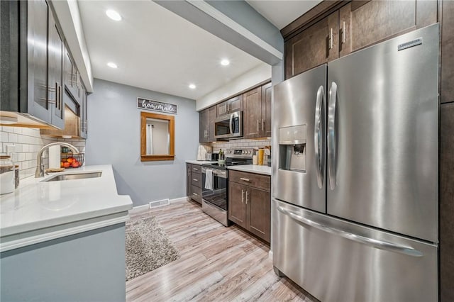 436 Allenberry Dr, Ross Twp, PA 15237 - kitchen featuring stainless steel appliances, a sink, tasteful backsplash, light countertops, and dark brown cabinets