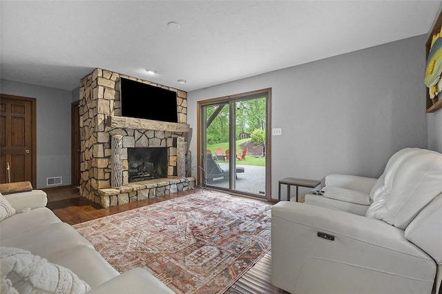 living room with wood finished floors and a fireplace