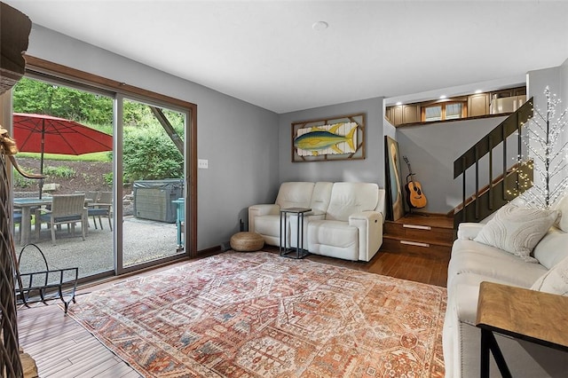 living area with wood finished floors and stairs
