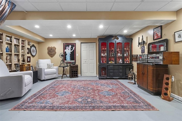 sitting room with a drop ceiling and recessed lighting