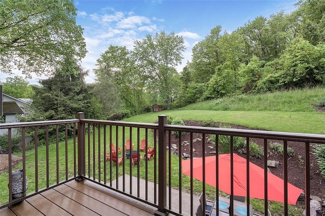 wooden deck featuring a lawn