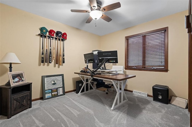 carpeted home office featuring ceiling fan and baseboards