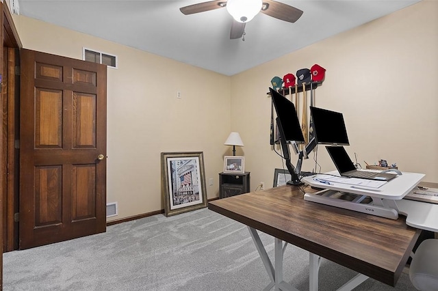 office with a ceiling fan, light carpet, and baseboards
