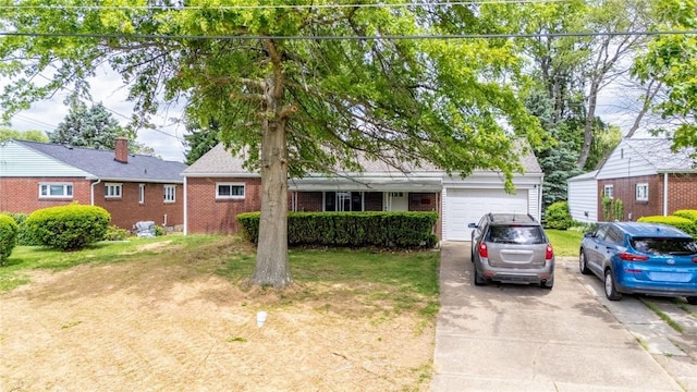 ranch-style house featuring an attached garage, concrete driveway, brick siding, and a front lawn