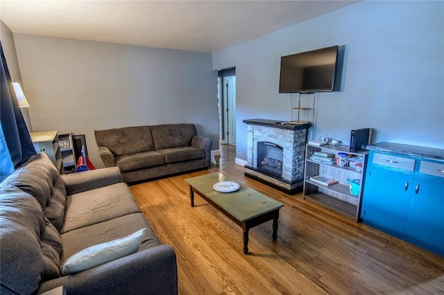 living area featuring wood finished floors and a fireplace