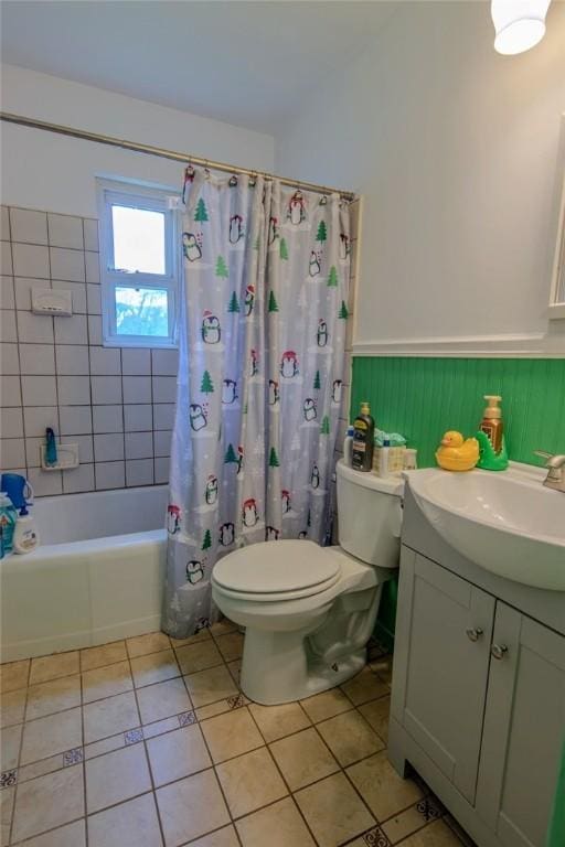 full bathroom featuring tile patterned floors, toilet, a wainscoted wall, shower / tub combo, and vanity