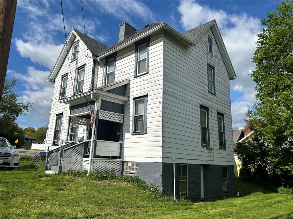 411 Cherry St, City Of But Ne, PA 16001 - view of side of home featuring a chimney and a lawn