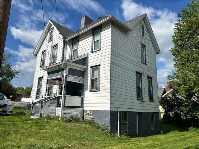 411 Cherry St, City Of But Ne, PA 16001 - view of side of home featuring a chimney and a lawn
