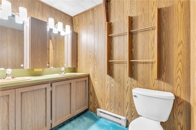 1445 E Cruikshank Rd, Valencia Boro, PA 16059 - bathroom featuring a baseboard radiator, wooden walls, toilet, and double vanity