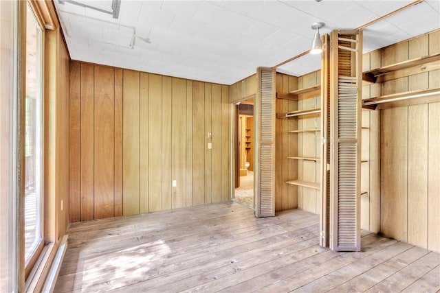 1445 E Cruikshank Rd, Valencia Boro, PA 16059 - unfurnished bedroom with wood walls and hardwood / wood-style flooring