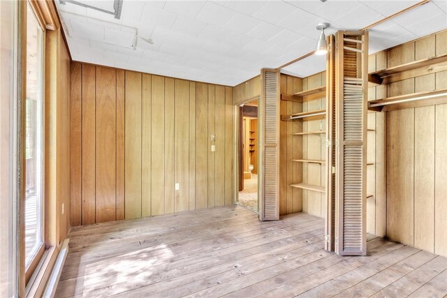 1445 E Cruikshank Rd, Valencia Boro, PA 16059 - unfurnished bedroom featuring wooden walls and wood-type flooring