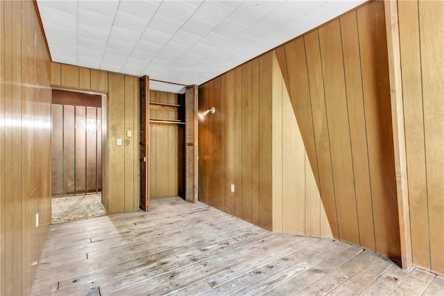 1445 E Cruikshank Rd, Valencia Boro, PA 16059 - unfurnished bedroom featuring wood walls, hardwood / wood-style floors, and elevator