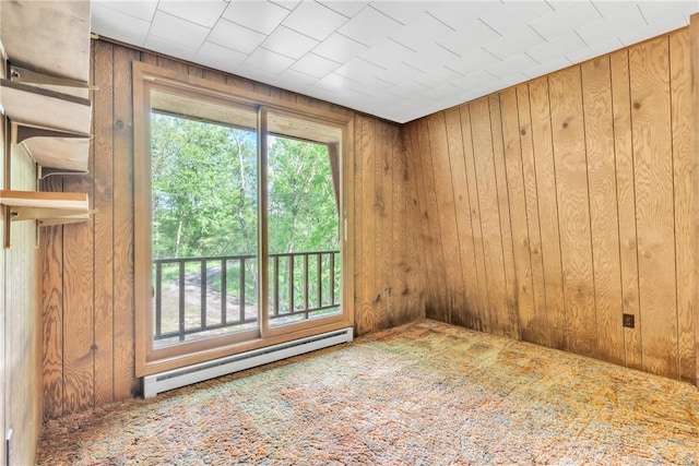 1445 E Cruikshank Rd, Valencia Boro, PA 16059 - empty room featuring a baseboard heating unit, wood walls, healthy amount of natural light, and carpet
