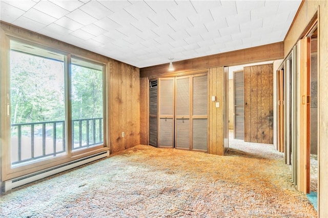 1445 E Cruikshank Rd, Valencia Boro, PA 16059 - unfurnished bedroom with a baseboard radiator, wooden walls, and carpet floors