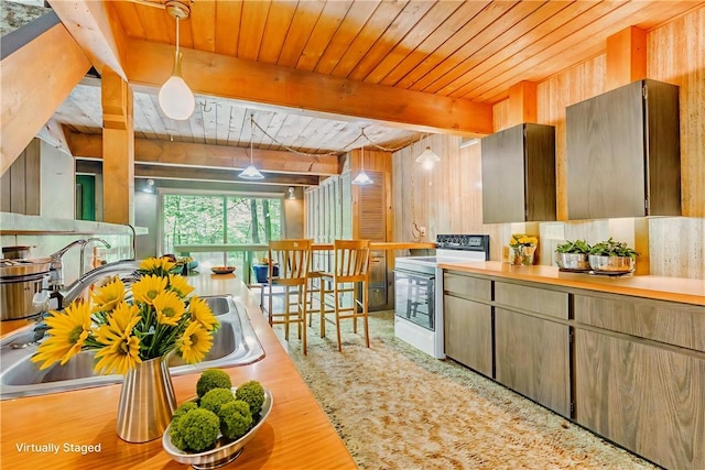 1445 E Cruikshank Rd, Valencia Boro, PA 16059 - kitchen with white electric stove, a wood ceiling with exposed beams, wood finished floors, decorative light fixtures, and wood walls