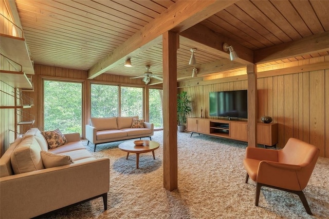 1445 E Cruikshank Rd, Valencia Boro, PA 16059 - carpeted living room featuring a wooden ceiling with exposed beams, wooden walls, and a ceiling fan