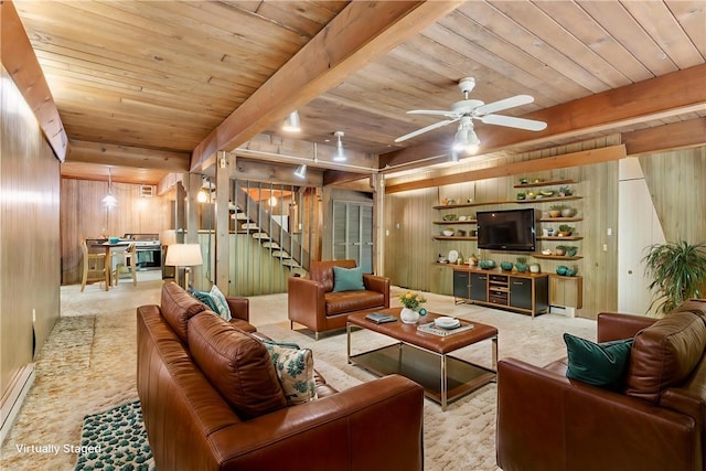 1445 E Cruikshank Rd, Valencia Boro, PA 16059 - living room with wood walls, a wooden ceiling with exposed beams, stairs, ceiling fan, and a baseboard radiator