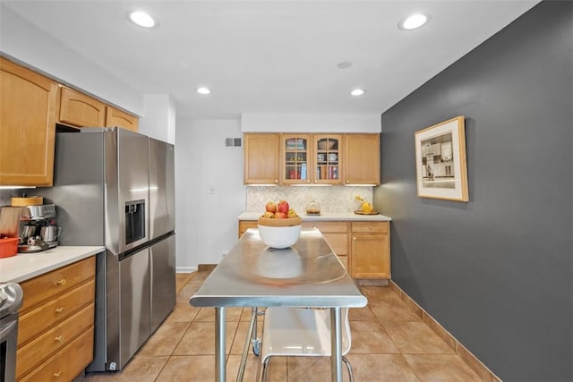 7134 Roycrest Pl, Point Breeze, PA 15208 - kitchen with stainless steel fridge, decorative backsplash, glass insert cabinets, light countertops, and recessed lighting