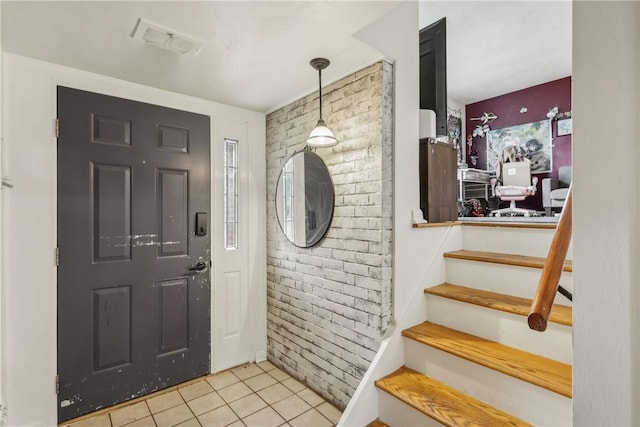 142 Meadowbrook Dr, Moon/Crescent Twp, PA 15108 - entryway featuring light tile patterned floors, brick wall, and stairs