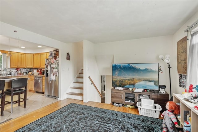 142 Meadowbrook Dr, Moon/Crescent Twp, PA 15108 - living room featuring light wood-style floors, stairs, and recessed lighting