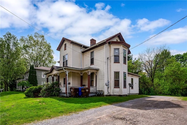 250 E Neshannock Ave, New Wilmington Boro, PA 16142 - view of front facade with covered porch, a chimney, and a front yard