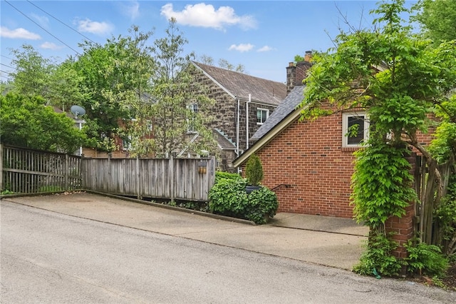 1017 Lancaster Ave, Regent Square, PA 15218 - view of side of home with brick siding and a chimney