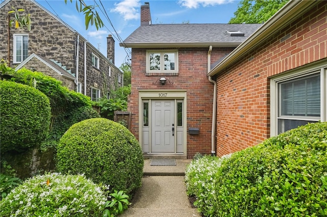 1017 Lancaster Ave, Regent Square, PA 15218 - entrance to property with brick siding, a chimney, and a shingled roof