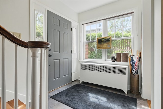 1017 Lancaster Ave, Regent Square, PA 15218 - foyer entrance featuring radiator, dark tile patterned flooring, and stairs